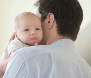 awake newborn baby being held