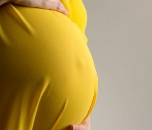 Pregnant with twins belly showing twin maternity clothes.