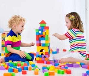 Twins playing with blocks. This post discusses the best toys for twin toddlers.