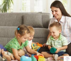 Mom playing with three little kids. This article discusses what it's like to have 3 under 3.
